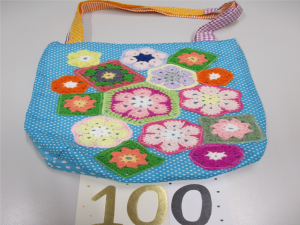 Hand made bag with 100 written below, signifying 100 bags made.