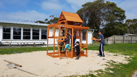 King Island Playground. Children playing whilst adult supervises.