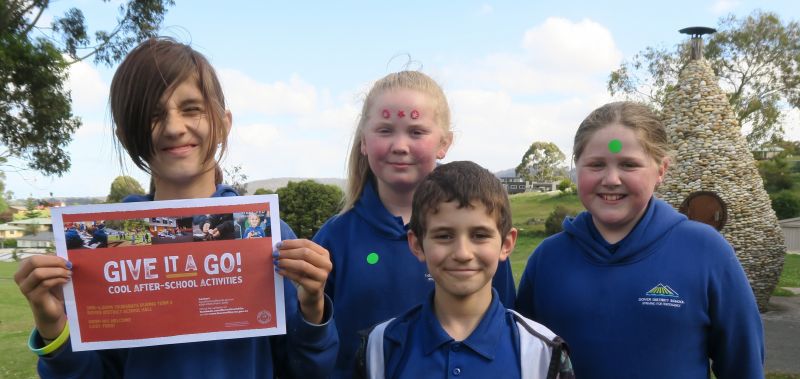 Four kids with sign that says Give it a Go - Cool after school activities