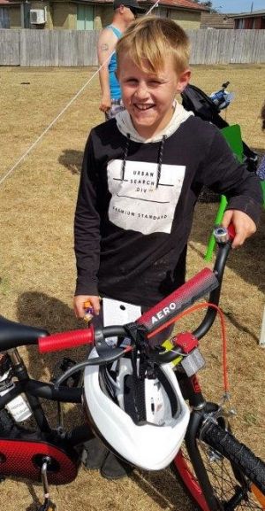 child with bike - Devonport Community House bicycle winners